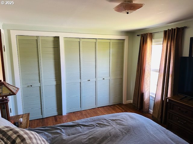 bedroom featuring baseboards and wood finished floors