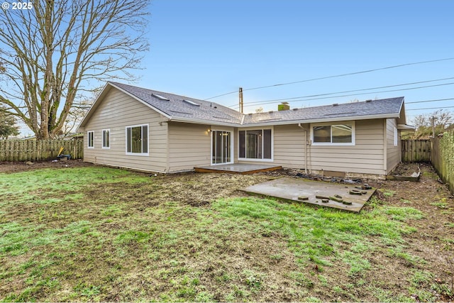 back of property featuring a patio area and a yard