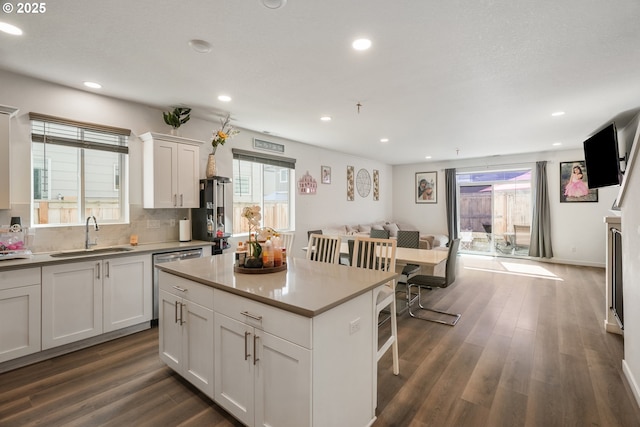 825 S 23rd Ave, Cornelius, OR 97113 - kitchen featuring a sink, stainless steel dishwasher, open floor plan, dark wood-type flooring, and white cabinets