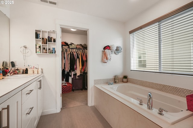 825 S 23rd Ave, Cornelius, OR 97113 - full bathroom featuring vanity, a bath, a walk in closet, and baseboards