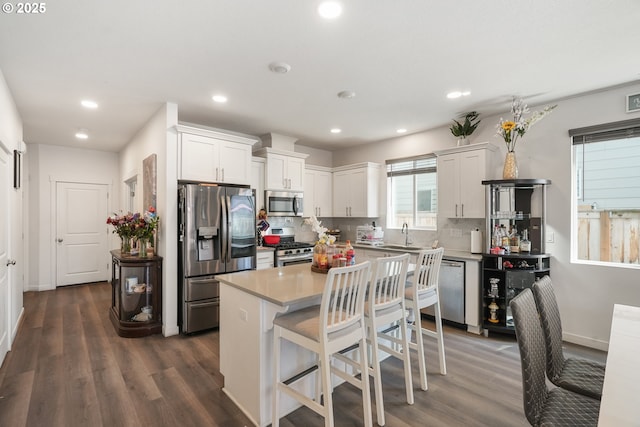 825 S 23rd Ave, Cornelius, OR 97113 - kitchen with stainless steel appliances, decorative backsplash, white cabinetry, dark wood-style floors, and recessed lighting