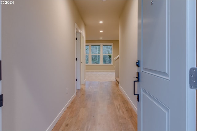 hall featuring light wood-style floors, recessed lighting, and baseboards