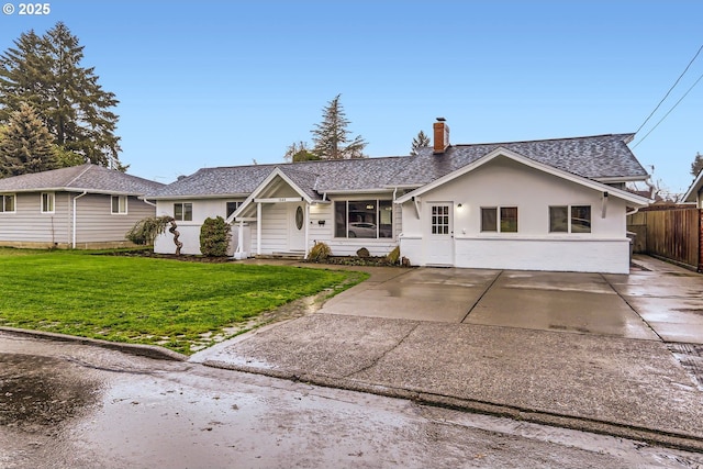 ranch-style home with a front yard