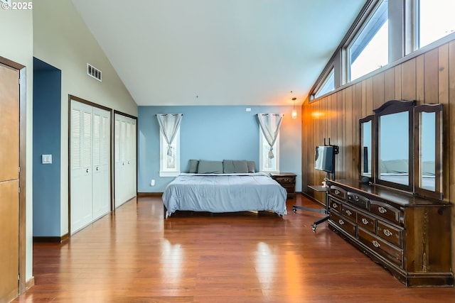 bedroom with hardwood / wood-style flooring and high vaulted ceiling