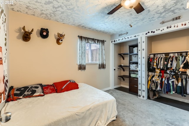 bedroom with a closet, dark carpet, and ceiling fan