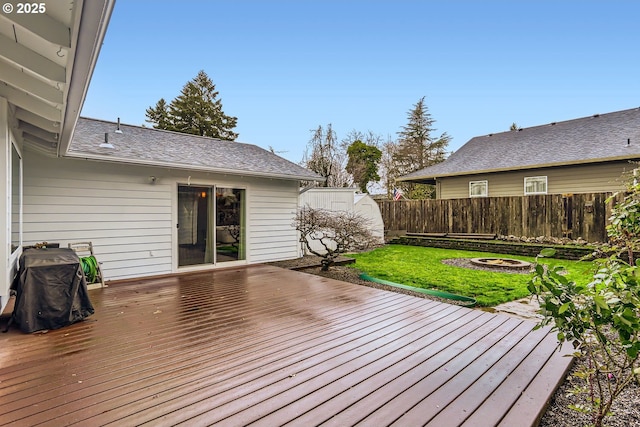 deck featuring a yard and an outdoor fire pit