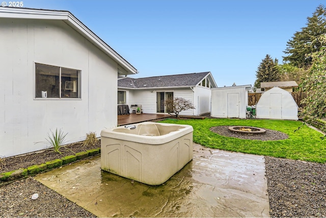 view of patio with a shed and an outdoor fire pit