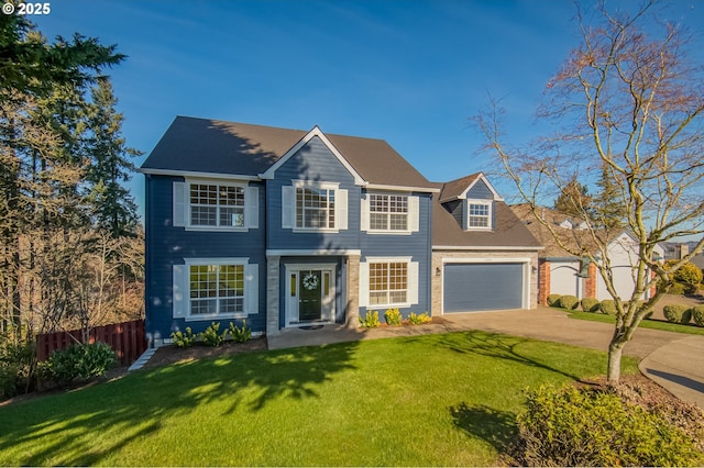 colonial home featuring a garage, driveway, a front lawn, and fence