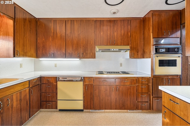 kitchen featuring cooktop, dishwasher, backsplash, and wall oven