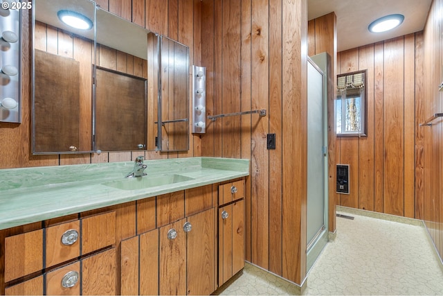 bathroom with vanity and wooden walls