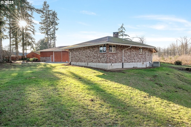 view of home's exterior with a garage and a lawn