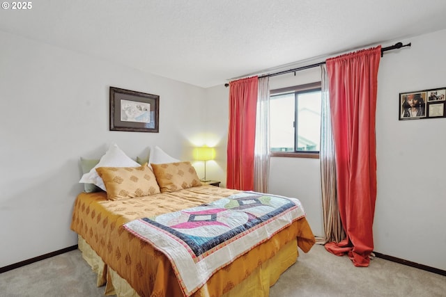 bedroom with a textured ceiling, baseboards, and carpet flooring