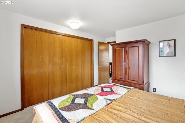 unfurnished bedroom with light carpet, baseboards, and a closet