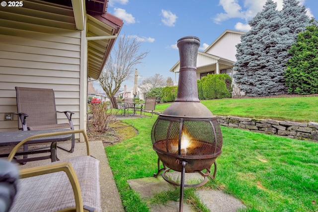 view of yard with an outdoor fire pit and a patio area