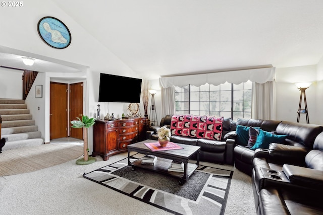 living area featuring high vaulted ceiling, stairway, and light colored carpet