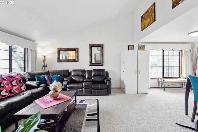 living area with carpet floors and high vaulted ceiling