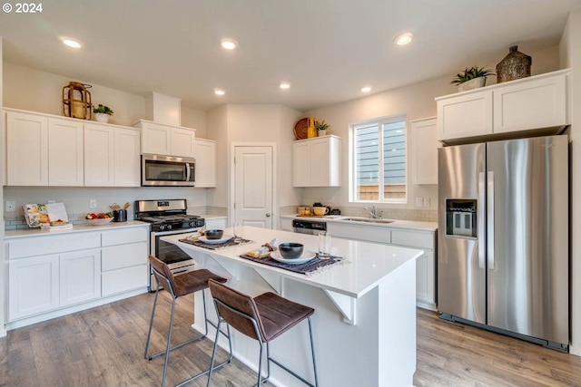 2891 V St, Springfield, OR 97477 - kitchen featuring stainless steel appliances, white cabinetry, a kitchen bar, a center island, and recessed lighting