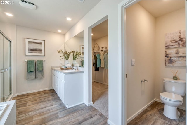2891 V St, Springfield, OR 97477 - full bath with wood finished floors, vanity, toilet, a walk in closet, and a shower with shower door