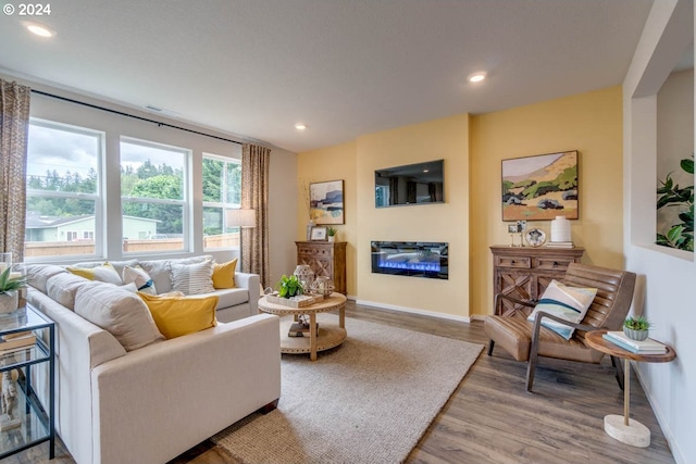 2891 V St, Springfield, OR 97477 - living area featuring baseboards, a glass covered fireplace, wood finished floors, and recessed lighting