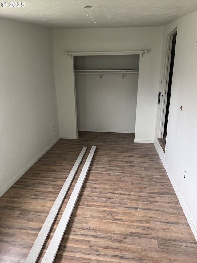 4545 Camellia St, Springfield, OR 97478 - unfurnished bedroom featuring a closet, wood finished floors, and baseboards