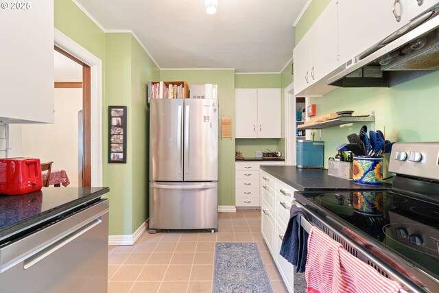 2406 SE 30th Ave, Portland, OR 97214 - kitchen featuring appliances with stainless steel finishes, white cabinets, crown molding, under cabinet range hood, and light tile patterned flooring