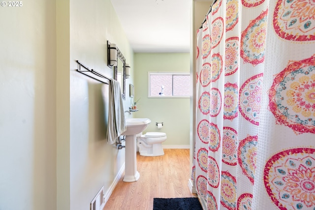 2406 SE 30th Ave, Portland, OR 97214 - bathroom with wood finished floors and curtained shower