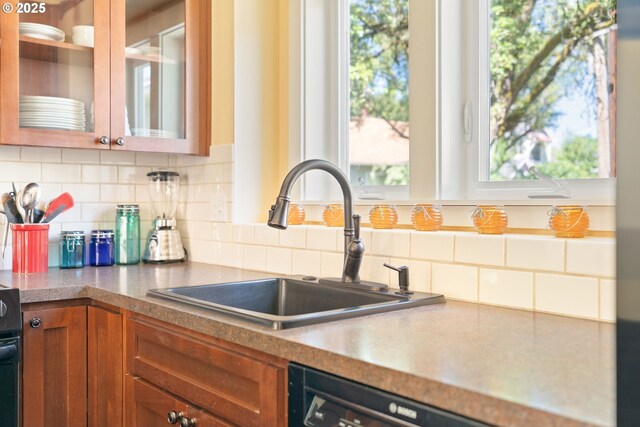 2406 SE 30th Ave, Portland, OR 97214 - kitchen featuring brown cabinets, glass insert cabinets, tasteful backsplash, and dishwasher