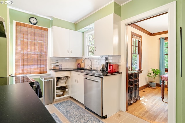 2406 SE 30th Ave, Portland, OR 97214 - kitchen featuring stainless steel dishwasher, ornamental molding, white cabinets, dark countertops, and healthy amount of natural light