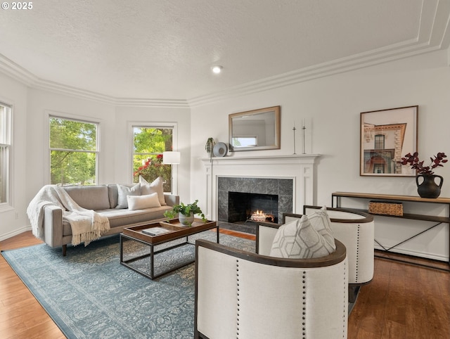 13460 Snowberry Ct, Lake Oswego, OR 97035 - living room with wood finished floors, ornamental molding, a high end fireplace, a textured ceiling, and recessed lighting