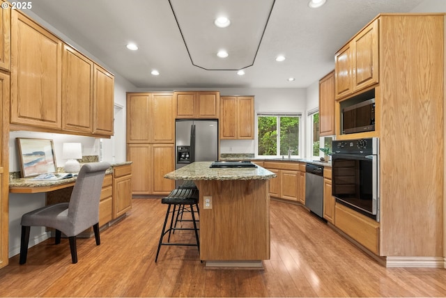13460 Snowberry Ct, Lake Oswego, OR 97035 - kitchen featuring appliances with stainless steel finishes, a sink, a breakfast bar, a kitchen island, and light wood-style flooring