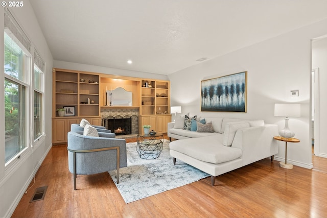 13460 Snowberry Ct, Lake Oswego, OR 97035 - living area featuring baseboards, wood finished floors, a lit fireplace, and recessed lighting