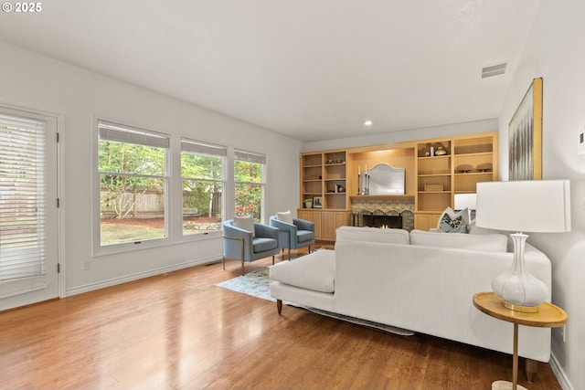 13460 Snowberry Ct, Lake Oswego, OR 97035 - living room with wood finished floors, baseboards, and a lit fireplace
