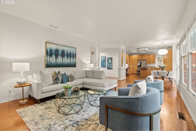 13460 Snowberry Ct, Lake Oswego, OR 97035 - living room featuring light wood-style flooring, baseboards, plenty of natural light, and recessed lighting