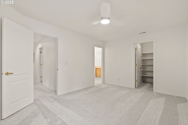 13460 Snowberry Ct, Lake Oswego, OR 97035 - unfurnished bedroom with light carpet, baseboards, a walk in closet, ensuite bathroom, and ceiling fan