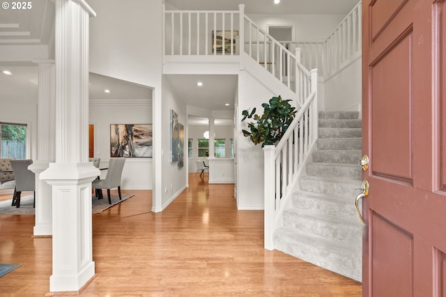 13460 Snowberry Ct, Lake Oswego, OR 97035 - entrance foyer featuring ornate columns, stairway, healthy amount of natural light, light wood-style flooring, and recessed lighting