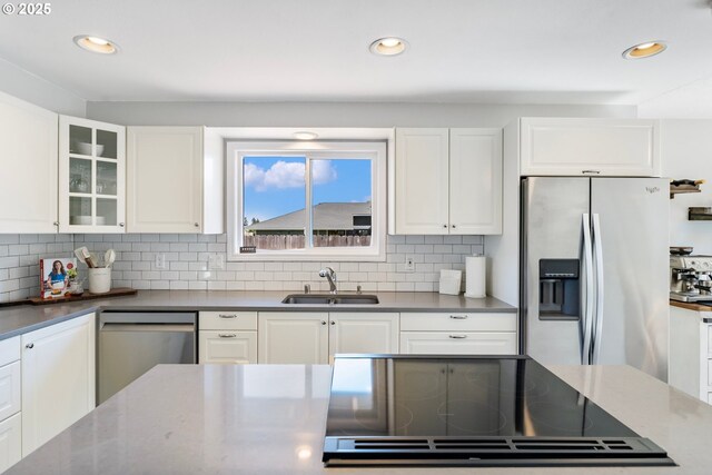 2824 SE 13th Ct, Hillsboro, OR 97123 - kitchen with stainless steel appliances, a sink, white cabinets, decorative backsplash, and recessed lighting