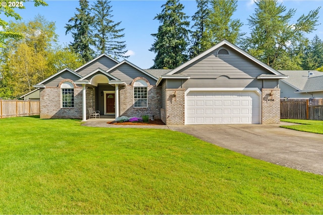 view of front of property featuring fence, an attached garage, brick siding, and a front yard