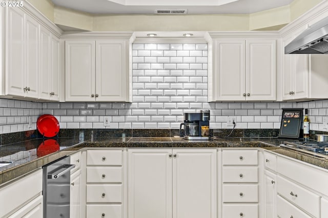 kitchen with custom exhaust hood, backsplash, and white cabinets