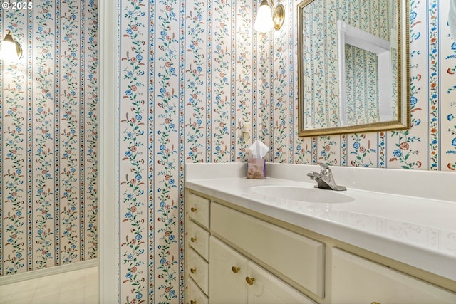 bathroom with vanity and wallpapered walls