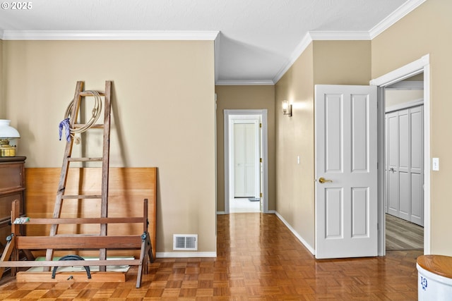 hall with ornamental molding, baseboards, and visible vents