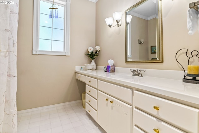 bathroom featuring baseboards, vanity, and crown molding