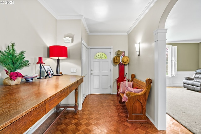 entryway featuring ornamental molding, decorative columns, and arched walkways