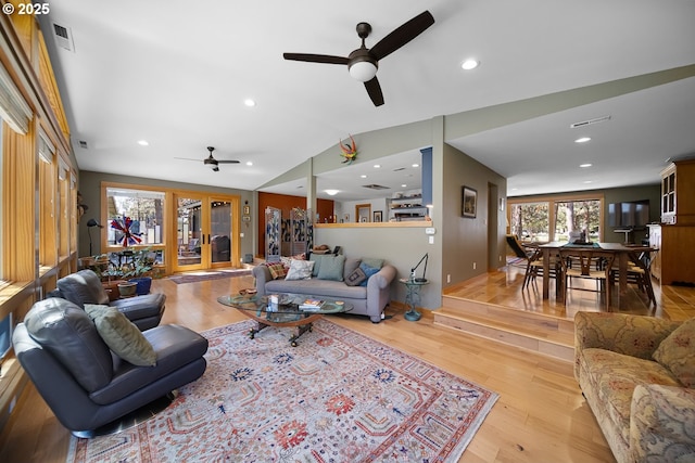 living area featuring recessed lighting, vaulted ceiling, light wood-type flooring, ceiling fan, and visible vents
