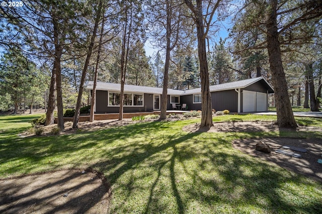view of front of house with a front yard, driveway, and an attached garage