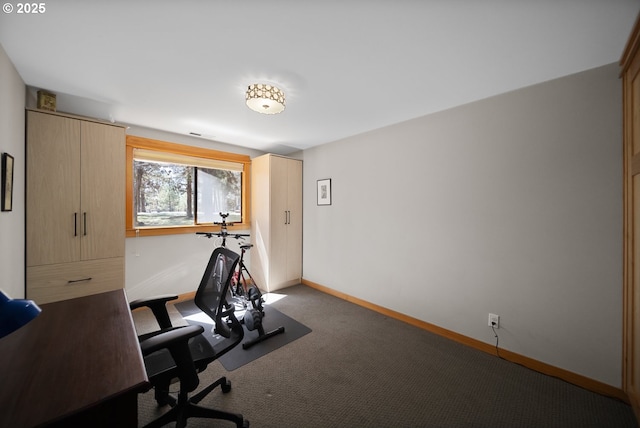 carpeted home office with baseboards