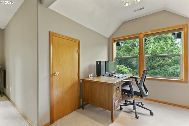 office space featuring light carpet, lofted ceiling, and baseboards