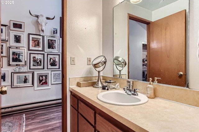 15940 SW 88th Ave, Tigard, OR 97224 - bathroom with a baseboard radiator, vanity, and wood finished floors