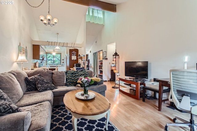 15940 SW 88th Ave, Tigard, OR 97224 - living room featuring high vaulted ceiling, a chandelier, and light wood-style flooring