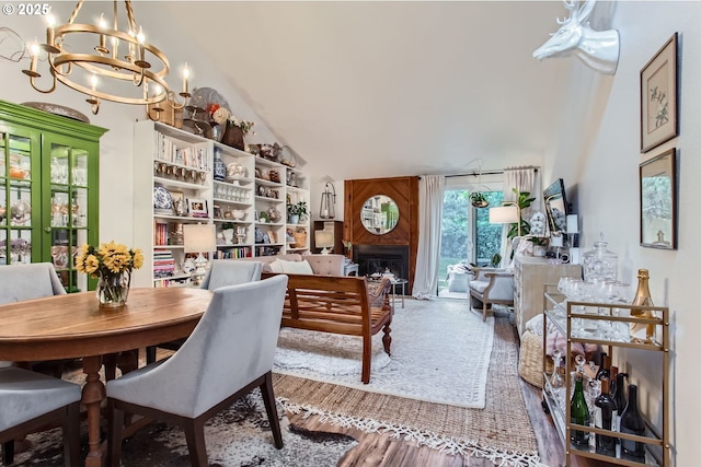 15940 SW 88th Ave, Tigard, OR 97224 - dining space with a chandelier, high vaulted ceiling, a fireplace, and wood finished floors