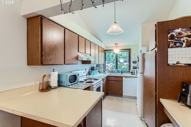 15940 SW 88th Ave, Tigard, OR 97224 - kitchen with white appliances, under cabinet range hood, a peninsula, light countertops, and decorative light fixtures